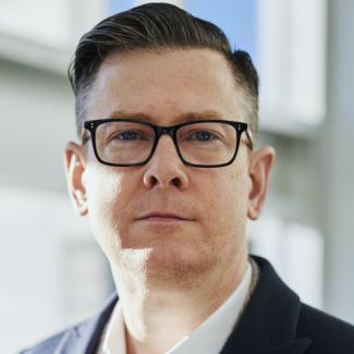 man in jacket with glasses