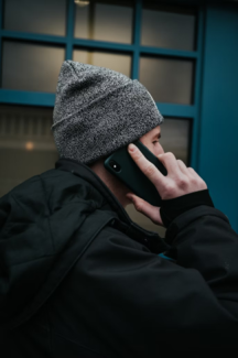 A person wearing a winter hat and talking on a cellphone