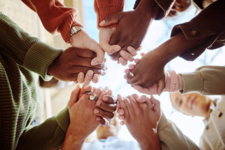 a group of people holding hands