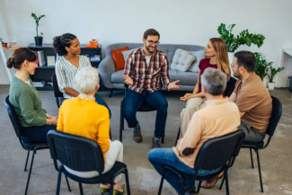 a group of people sitting in a circle and talking