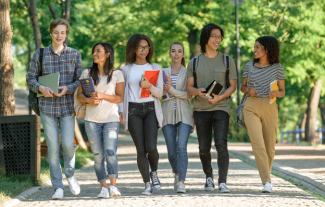 A group of college students walking around campus and talking