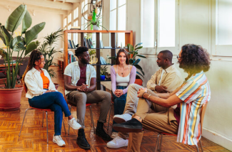 a group of people sitting in a circle and talking